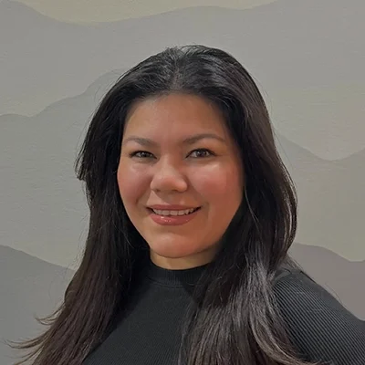 Thelma’ smiling in a black shirt.